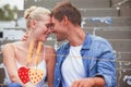 Composite image of hip young couple in denim sitting on steps Royalty Free Stock Photo