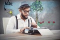 Composite image of hipster holding smoking pipe while working on Royalty Free Stock Photo