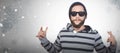 Composite image of hipster showing rock and roll hand sign Royalty Free Stock Photo