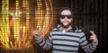 Composite image of hipster showing rock and roll hand sign Royalty Free Stock Photo