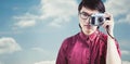 Composite image of hipster taking pictures with an old camera Royalty Free Stock Photo