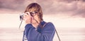 Composite image of hipster taking pictures with an old camera Royalty Free Stock Photo