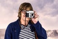 Composite image of hipster taking pictures with an old camera Royalty Free Stock Photo