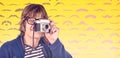 Composite image of hipster taking pictures with an old camera Royalty Free Stock Photo