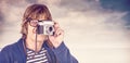 Composite image of hipster taking pictures with an old camera Royalty Free Stock Photo