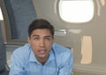 Composite image of hispanic young man against airplane window in background