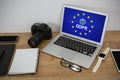 Composite image of laptop, wristwatch, notepad, camera and mobile phone on wooden table Royalty Free Stock Photo