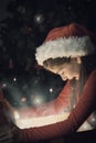 Composite image of little girl opening a magical christmas gift Royalty Free Stock Photo