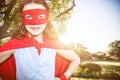 Composite image of little girl pretending to be a superhero