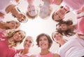 Composite image of low angle portrait of female friends supporting breast cancer Royalty Free Stock Photo