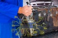 Composite image of male mechanic repairing car engine