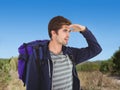 Composite image of man with backpack shielding eyes Royalty Free Stock Photo