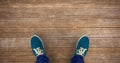 Composite image of man with canvas shoes on hardwood floor Royalty Free Stock Photo