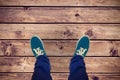 Composite image of man with canvas shoes on hardwood floor Royalty Free Stock Photo