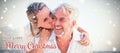 Composite image of man giving his smiling wife a piggy back at the beach Royalty Free Stock Photo