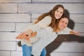 Composite image of man giving piggy back to his girlfriend Royalty Free Stock Photo