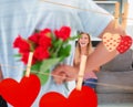 Composite image of man hiding bouquet of roses from smiling girlfriend on the couch