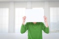 Composite image of man holding blank sign in front of face Royalty Free Stock Photo