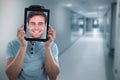 Composite image of man holding digital tablet in front of face Royalty Free Stock Photo