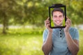 Composite image of man holding digital tablet in front of face Royalty Free Stock Photo