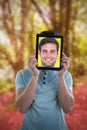 Composite image of man holding digital tablet in front of face Royalty Free Stock Photo