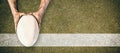 Composite image of man holding rugby ball