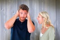 Composite image of man not listening to his shouting girlfriend Royalty Free Stock Photo