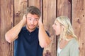 Composite image of man not listening to his shouting girlfriend Royalty Free Stock Photo