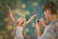 Composite image of man taking photo of his pretty girlfriend Royalty Free Stock Photo