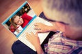 Composite image of man using laptop while sitting on floor at home Royalty Free Stock Photo