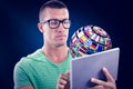 Composite image of man wearing glasses while using tablet computer Royalty Free Stock Photo