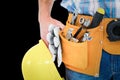 Composite image of manual worker wearing tool belt while holding gloves and helmet Royalty Free Stock Photo