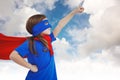 Composite image of masked girl pretending to be superhero