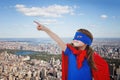 Composite image of masked girl pretending to be superhero