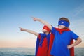 Composite image of masked kids pretending to be superheroes Royalty Free Stock Photo