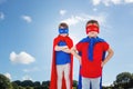 Composite image of masked kids pretending to be superheroes Royalty Free Stock Photo