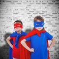 Composite image of masked kids pretending to be superheroes Royalty Free Stock Photo