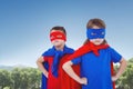 Composite image of masked kids pretending to be superheroes Royalty Free Stock Photo