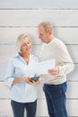 Composite image of mature couple working out their bills Royalty Free Stock Photo