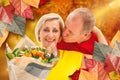 Composite image of mature man kissing his partner holding flowers Royalty Free Stock Photo