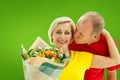 Composite image of mature man kissing his partner holding flowers Royalty Free Stock Photo