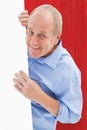 Composite image of mature man smiling at camera around card Royalty Free Stock Photo