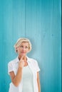 Composite image of mature woman thinking with hand on chin Royalty Free Stock Photo