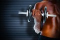 Composite image of mid section of fit shirtless man holding dumbbell