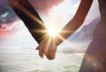 Composite image of mid section of newlywed couple holding hands in park Royalty Free Stock Photo