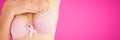 Composite image of mid section of woman in bra for breast cancer awareness Royalty Free Stock Photo