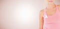 Composite image of mid section of woman wearing breast cancer awareness ribbon Royalty Free Stock Photo
