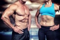 Composite image of midsection of muscular man and woman with hands on hip