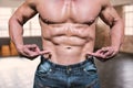 Composite image of midsection of shirtless man pointing at abs Royalty Free Stock Photo