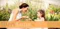 Composite image of mother and daughter collecting easter eggs Royalty Free Stock Photo